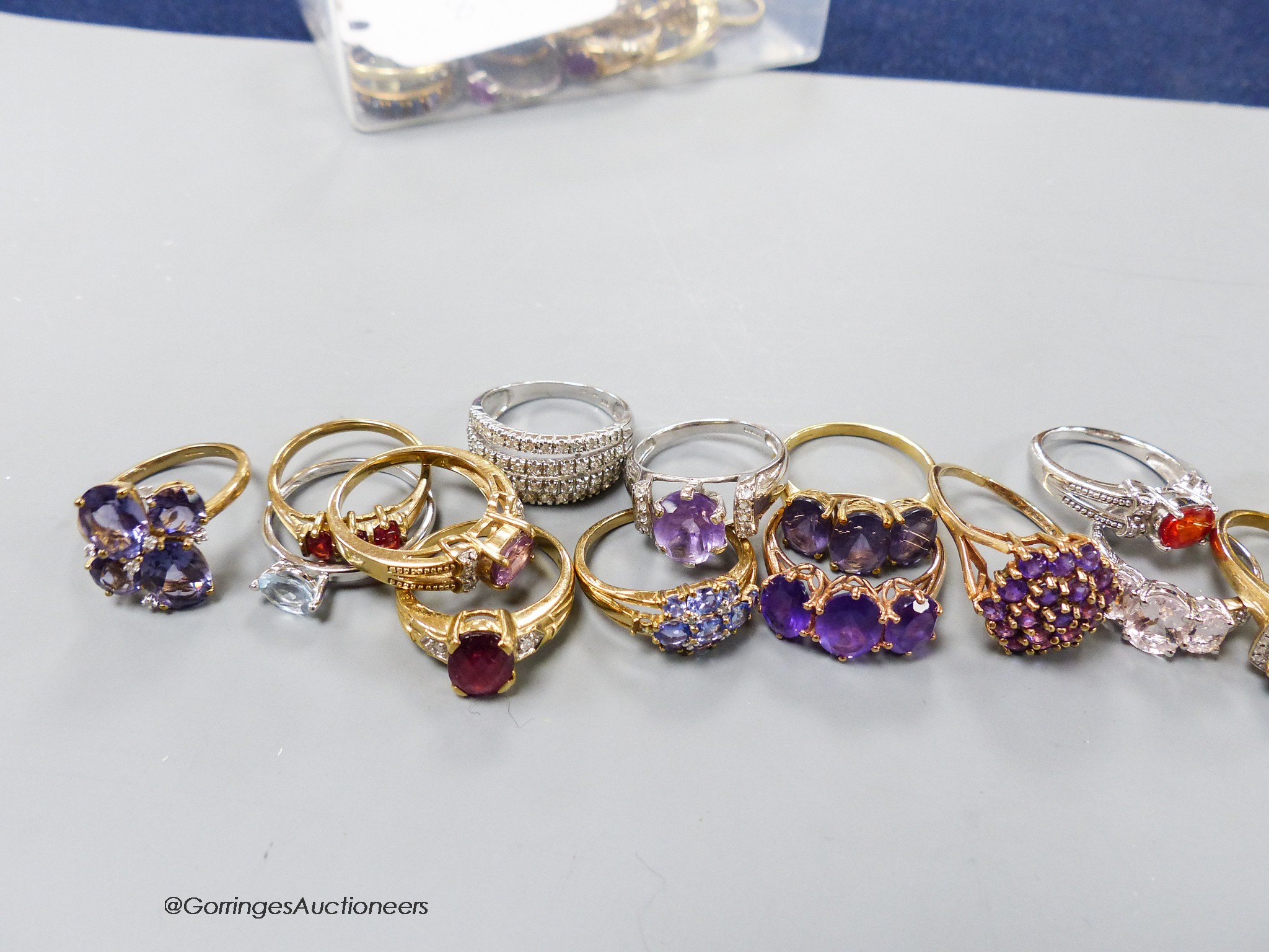 Twenty assorted modern 9ct or 9k and gem set dress rings, gross 60 grams.